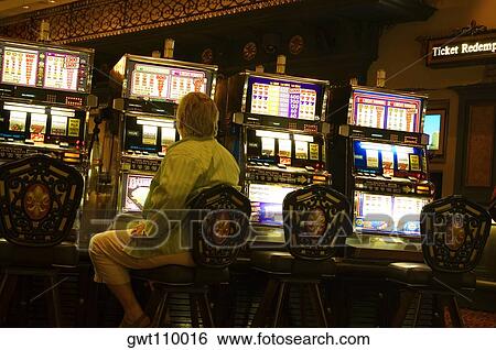 Rear view of a man sitting at a slot machine, New Orleans, Louisiana, USA View Large Photo Image Stock Photograph - Rear view of a man sitting at a slot machine, New Orleans, Louisiana, USA. Fotosearch