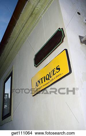 Picture - Low angle view of two sign boards on the wall, Czech Republic. Fotosearch