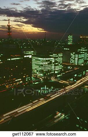 Aerial view of skyscrapers lit up at night, Osaka, Japan View Large Photo Image Stock Photo - Aerial view of skyscrapers lit up at night, Osaka, Japan. Fotosearch