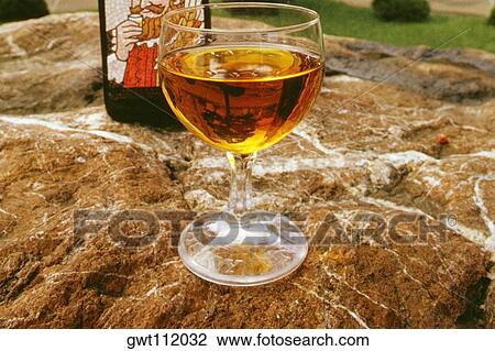 Stock Image - Close-up of a glass of whiskey and a bottle, Nikka Distillery, Otaru, Hokkaido, Japan. Fotosearch