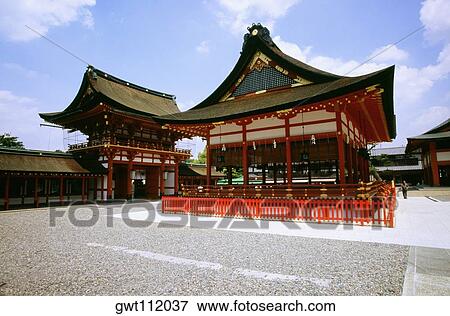 Stock Photo - Man standing in a temple, Fushimi-Inari Shrine, Kyoto, Japan. Fotosearch