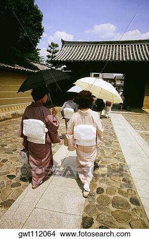 Rear view of two mid adult women walking on a walkway, Daitokuji Temple, Kyoto, Japan View Large Photo Image Picture - Rear view of two mid adult women walking on a walkway, Daitokuji Temple, Kyoto, Japan. Fotosearch