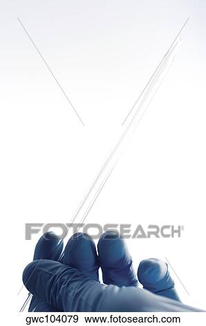Close-up of a pipette in a person's hand View Large Photo Image Stock Photo - Close-up of a pipette in a person's hand. Fotosearch
