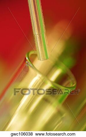 Close-up of a dropper over a test tube View Large Photo Image Stock Photo - Close-up of a dropper over a test tube. Fotosearch