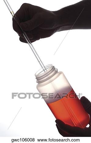 Close-up of a jar and dropper in a person's hand View Large Photo Image Stock Photo - Close-up of a jar and dropper in a person's hand. Fotosearch