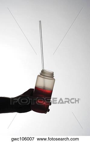 Close-up of a jar in a person's hand View Large Photo Image Stock Photo - Close-up of a jar in a person's hand. Fotosearch