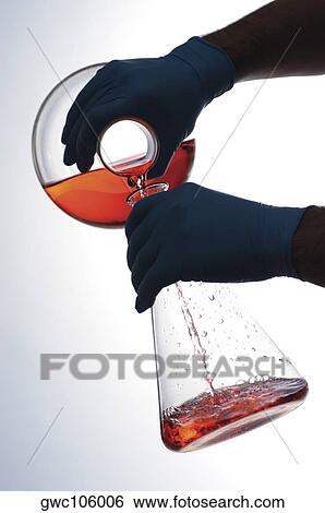 Close-up of a person pouring liquid into a beaker View Large Photo Image Stock Photograph - Close-up of a person pouring liquid into a beaker. Fotosearch