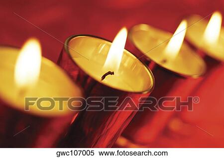 Close-up of a row of lit candles in glasses View Large Photo Image Stock Photography - Close-up of a row of lit candles in glasses. Fotosearch