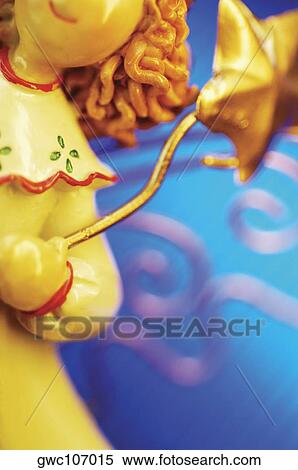 Close-up of an angel figurine View Large Photo Image Stock Photography - Close-up of an angel figurine. Fotosearch