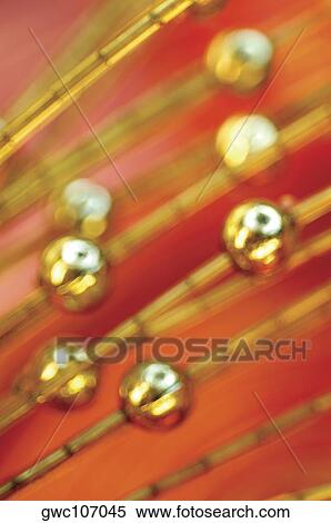 Close-up of golden beads View Large Photo Image Stock Photography - Close-up of golden beads. Fotosearch