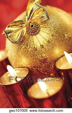 Close-up of lit candles around a Christmas ball View Large Photo Image Stock Photo - Close-up of lit candles around a Christmas ball. Fotosearch