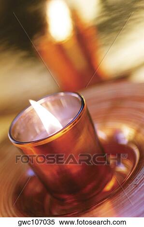 High angle view of a lit candle in a glass View Large Photo Image Stock Photography - High angle view of a lit candle in a glass. Fotosearch
