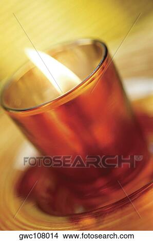 Close-up of a lit candle in a glass View Large Photo Image Picture - Close-up of a lit candle in a glass. Fotosearch