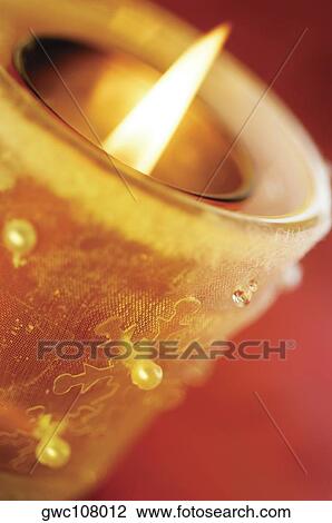 Close-up of a lit candle View Large Photo Image Stock Image - Close-up of a lit candle. Fotosearch