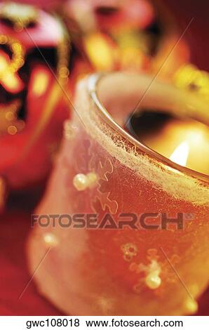 Stock Photo - Close-up of a lit candle. Fotosearch