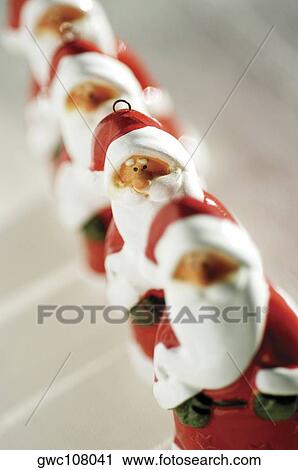 Close-up of a row of Santa Claus figurines View Large Photo Image Stock Image - Close-up of a row of Santa Claus figurines. Fotosearch