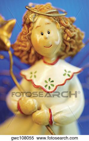 Close-up of an angel figurine View Large Photo Image Stock Photography - Close-up of an angel figurine. Fotosearch