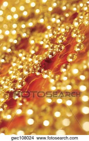 Picture - Close-up of golden beads. Fotosearch