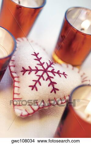 High angle view of a heart shaped cushion with lit candles in glasses around it View Large Photo Image Picture - High angle view of a heart shaped cushion with lit candles in glasses around it. Fotosearch