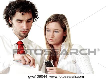 Picture - Businessman and a businesswoman discussing documents. Fotosearch