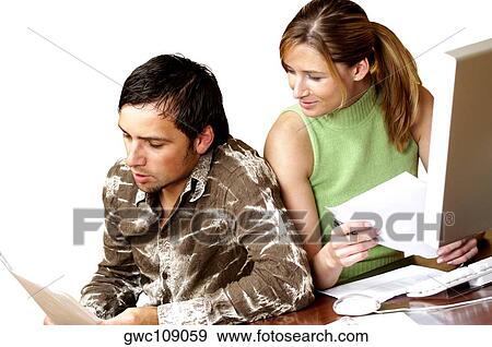 Stock Photo - Businessman and a businesswoman reading documents. Fotosearch
