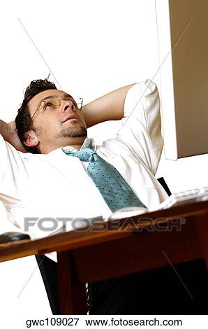 Businessman relaxing in an office View Large Photo Image Stock Photo - Businessman relaxing in an office. Fotosearch