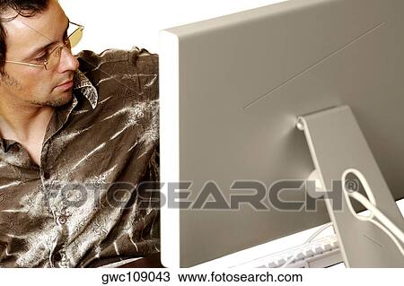 Businessman sitting in front of a computer monitor View Large Photo Image Stock Image - Businessman sitting in front of a computer monitor. Fotosearch