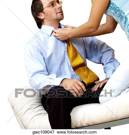 Businesswoman adjusting a businessman's tie View Large Photo Image Stock Photo - Businesswoman adjusting a businessman's tie. Fotosearch