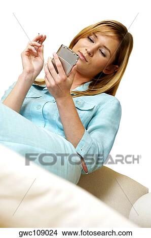 Picture - Businesswoman operating a personal data assistant. Fotosearch