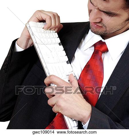 Close-up of a businessman holding a computer keyboard in frustration View Large Photo Image Picture - Close-up of a businessman holding a computer keyboard in frustration. Fotosearch
