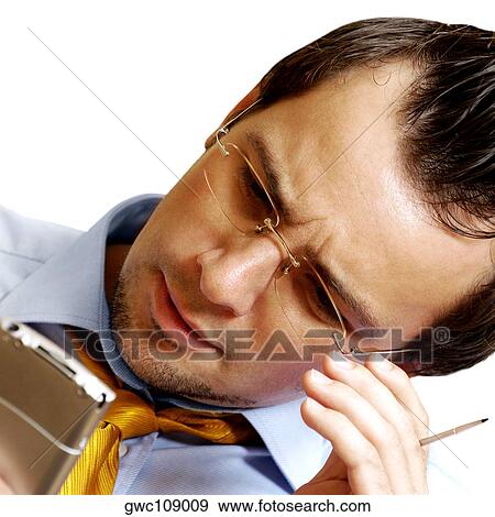 Stock Photo - Close-up of a businessman operating a personal data assistant. Fotosearch