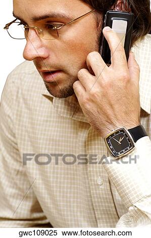 Close-up of a businessman talking on a mobile phone View Large Photo Image Stock Photography - Close-up of a businessman talking on a mobile phone. Fotosearch