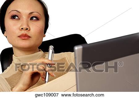 Close-up of a businesswoman holding a pen and thinking View Large Photo Image Stock Photo - Close-up of a businesswoman holding a pen and thinking. Fotosearch