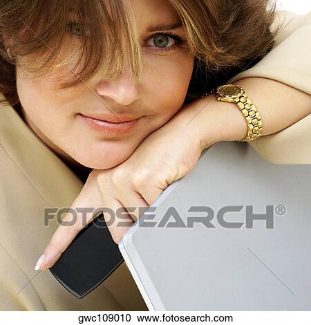 Close-up of a businesswoman leaning on a laptop View Large Photo Image Stock Image - Close-up of a businesswoman leaning on a laptop. Fotosearch