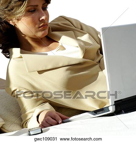 Stock Image - Close-up of a businesswoman working on a laptop. Fotosearch