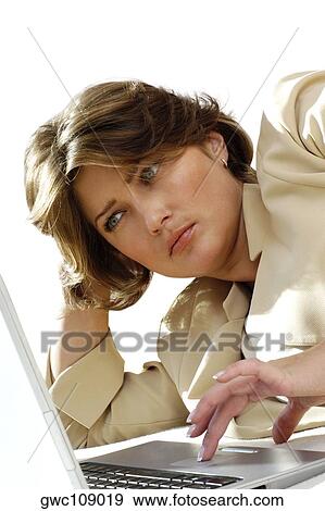 Stock Photo - Close-up of a businesswoman working on a laptop. Fotosearch