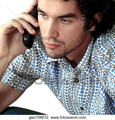 Close-up of a young man talking on a mobile phone View Large Photo Image Stock Image - Close-up of a young man talking on a mobile phone. Fotosearch