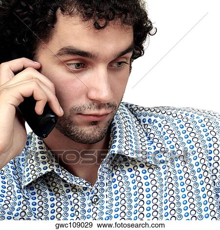 Close-up of a young man talking on a mobile phone View Large Photo Image Stock Photo - Close-up of a young man talking on a mobile phone. Fotosearch