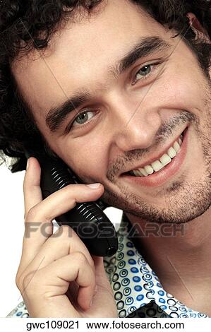 Portrait of a young man talking on a mobile phone View Large Photo Image Stock Image - Portrait of a young man talking on a mobile phone. Fotosearch