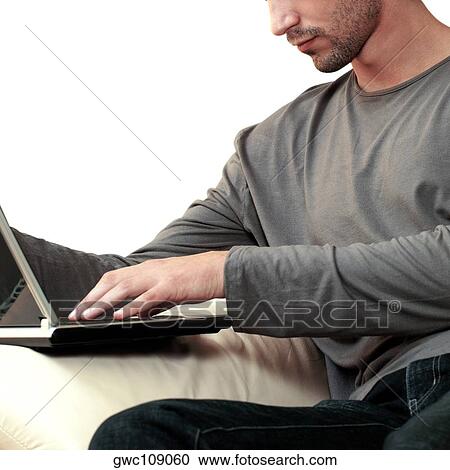 Side profile of a young man using a laptop View Large Photo Image Stock Image - Side profile of a young man using a laptop. Fotosearch