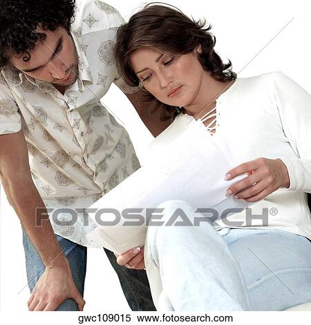 Young couple reading papers View Large Photo Image Stock Photography - Young couple reading papers. Fotosearch