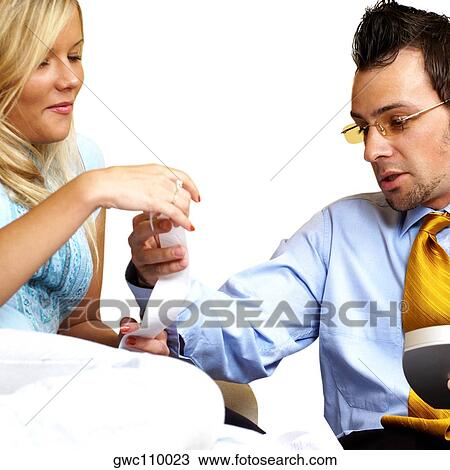 Stock Image - Businessman and a businesswoman holding a bill. Fotosearch