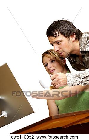 Businessman and a businesswoman in front of a computer View Large Photo Image Stock Image - Businessman and a businesswoman in front of a computer. Fotosearch