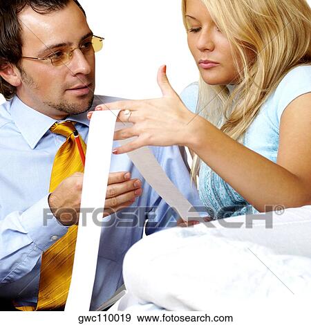 Businessman and a businesswoman looking at a bill View Large Photo Image Stock Photo - Businessman and a businesswoman looking at a bill. Fotosearch