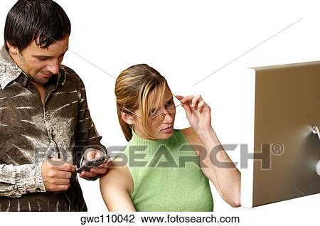 Businessman using a personal data assistant with a businesswoman sitting beside him View Large Photo Image Stock Image - Businessman using a personal data assistant with a businesswoman sitting beside him. Fotosearch