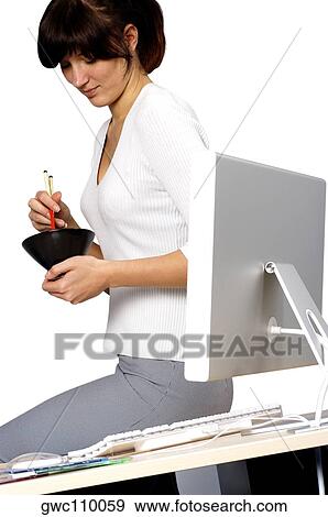 Businesswoman holding chopsticks and a bowl View Large Photo Image Stock Photo - Businesswoman holding chopsticks and a bowl. Fotosearch