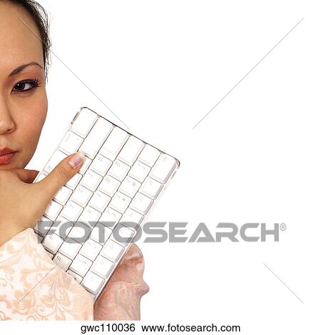 Close-up of a businesswoman holding a computer keyboard View Large Photo Image Stock Photograph - Close-up of a businesswoman holding a computer keyboard. Fotosearch