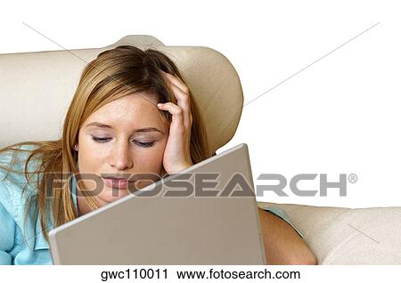 Close-up of a businesswoman lying on a couch in front of a laptop View Large Photo Image Stock Image - Close-up of a businesswoman lying on a couch in front of a laptop. Fotosearch