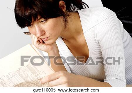 Close-up of a businesswoman reading a financial page View Large Photo Image Stock Photography - Close-up of a businesswoman reading a financial page. Fotosearch