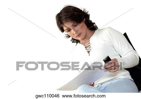 Stock Photograph - Close-up of a businesswoman reading documents. Fotosearch